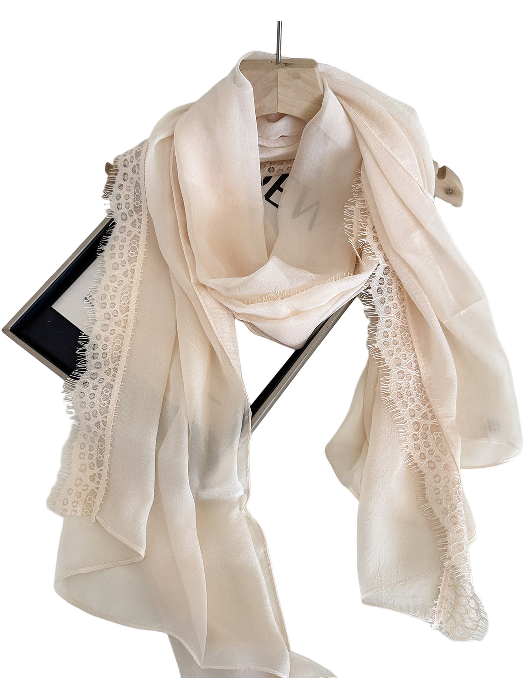 Cream scarf with lace trim and eyelash fringe, draped detail view