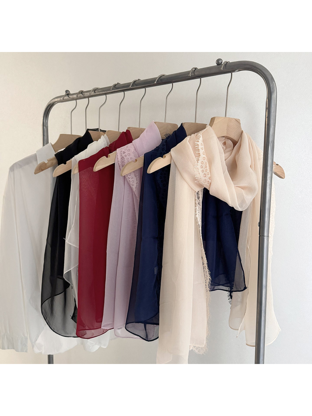 Scarves in six colors hanging together with lace borders visible