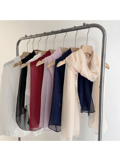 Scarves in six colors hanging together with lace borders visible