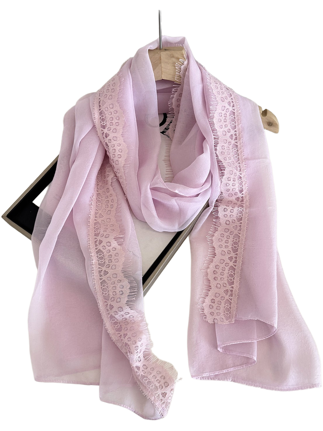Pink scarf draped in a loop with lace borders and eyelash fringe