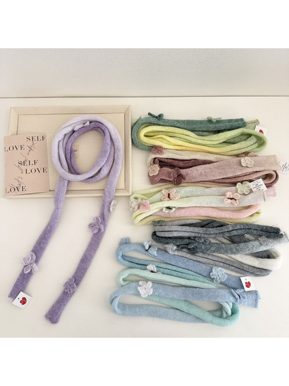 Knitted scarves in six gradient colorways with raised flower and butterfly embellishments