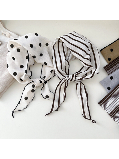 Ivory polka dot and single striped scarves tied side by side