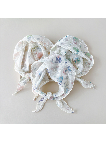 Three floral scarves with white embroidery arranged in tied loops