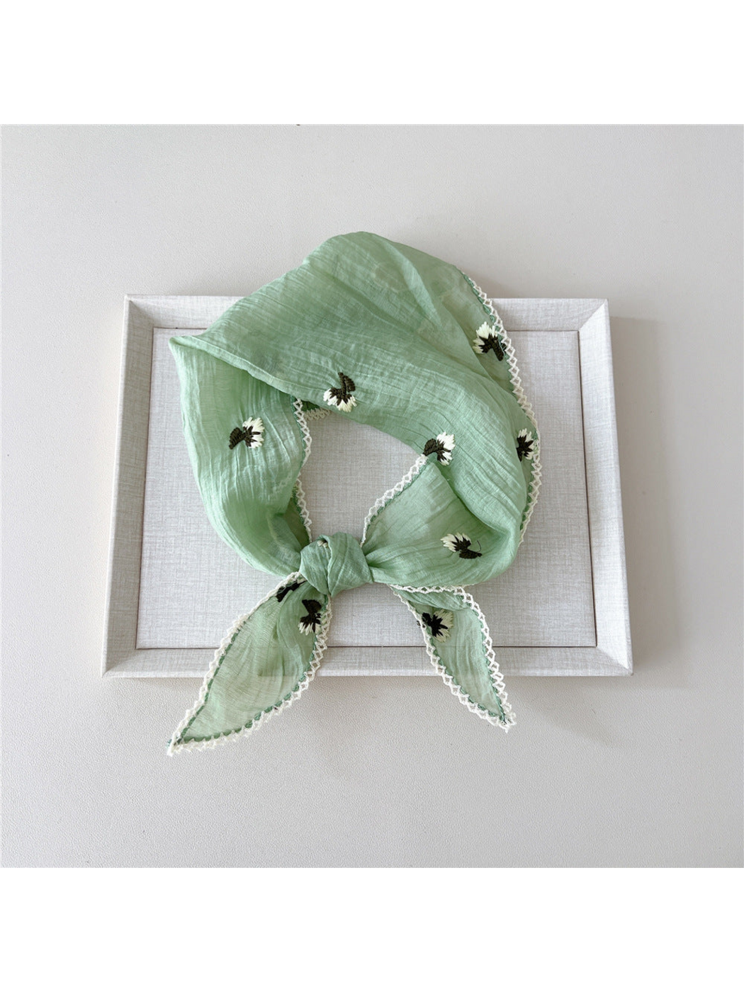 Mint floral scarf in a knotted loop with white openwork edge trim
