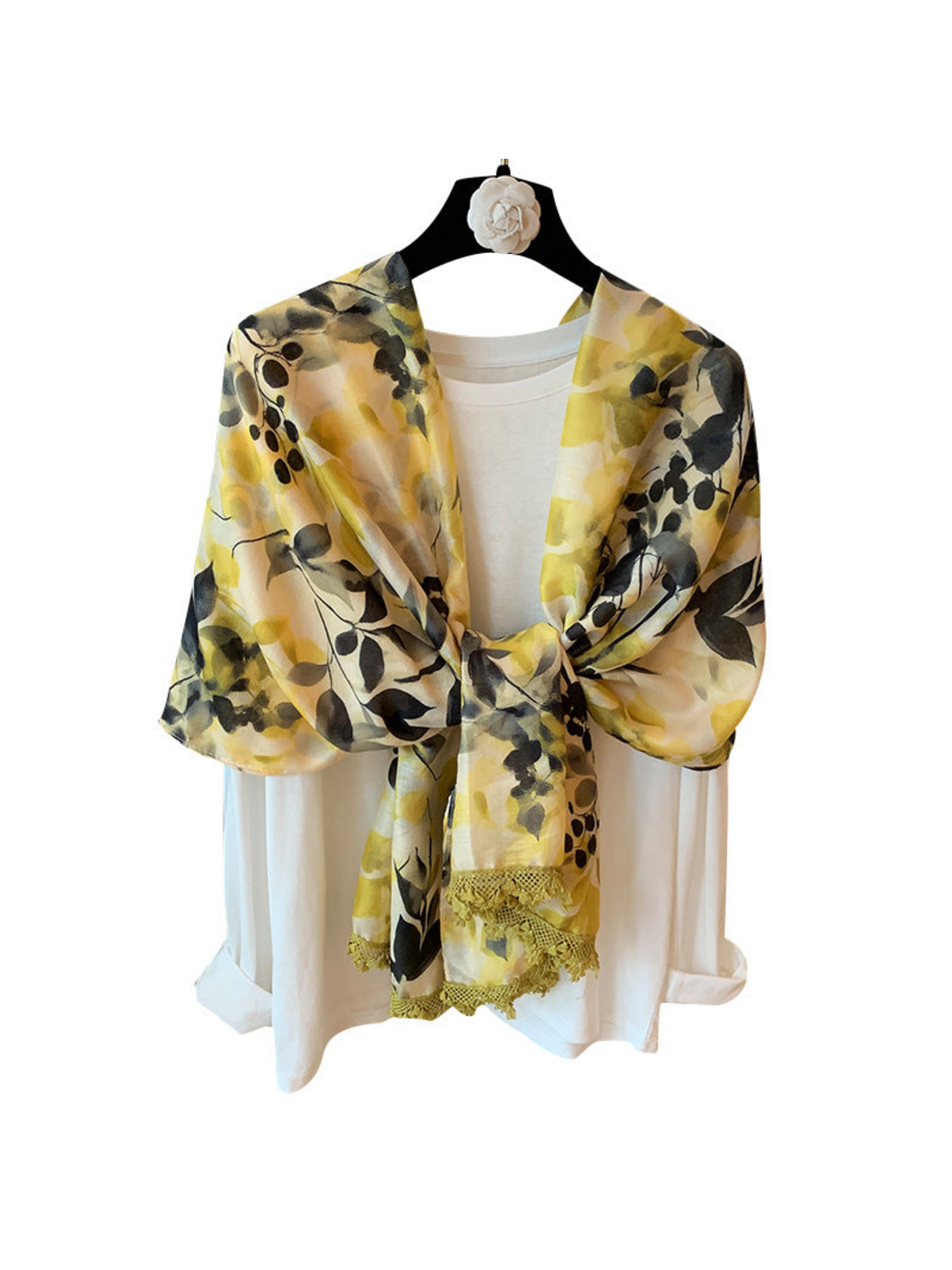 Multicolor botanical-print scarf tied at the front, with yellow-green lace trim, on a white background