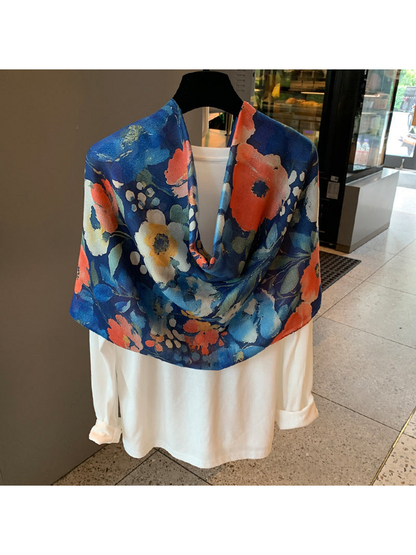 Multicolor floral scarf in a broad loop over a white top