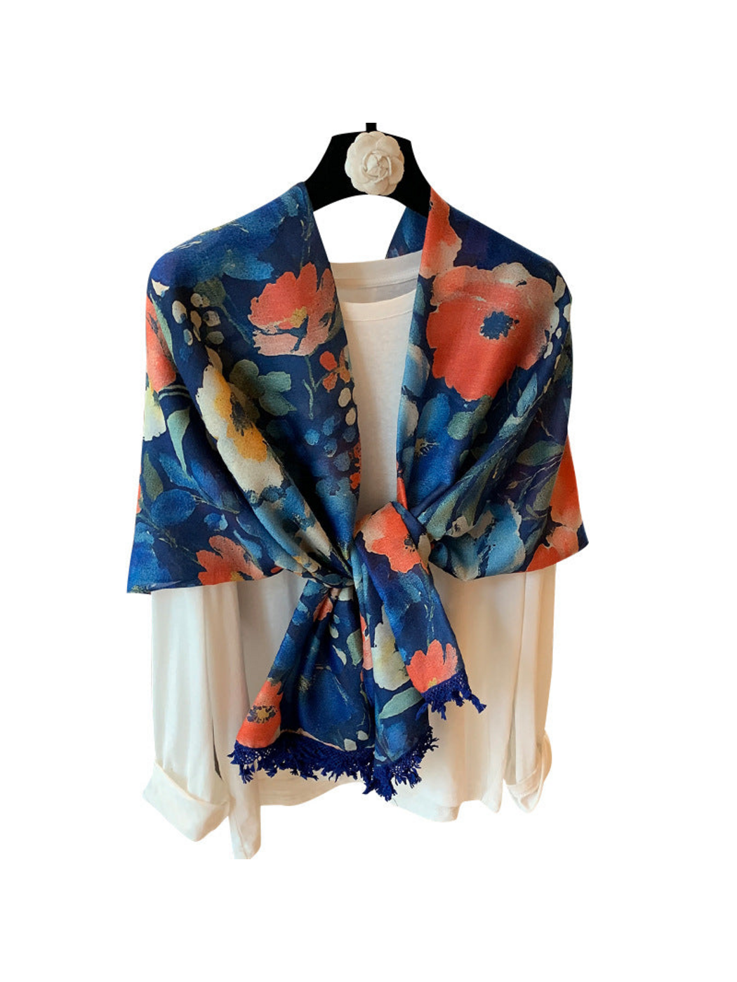 Multicolor floral scarf tied at the front over a white top, with fringed edges
