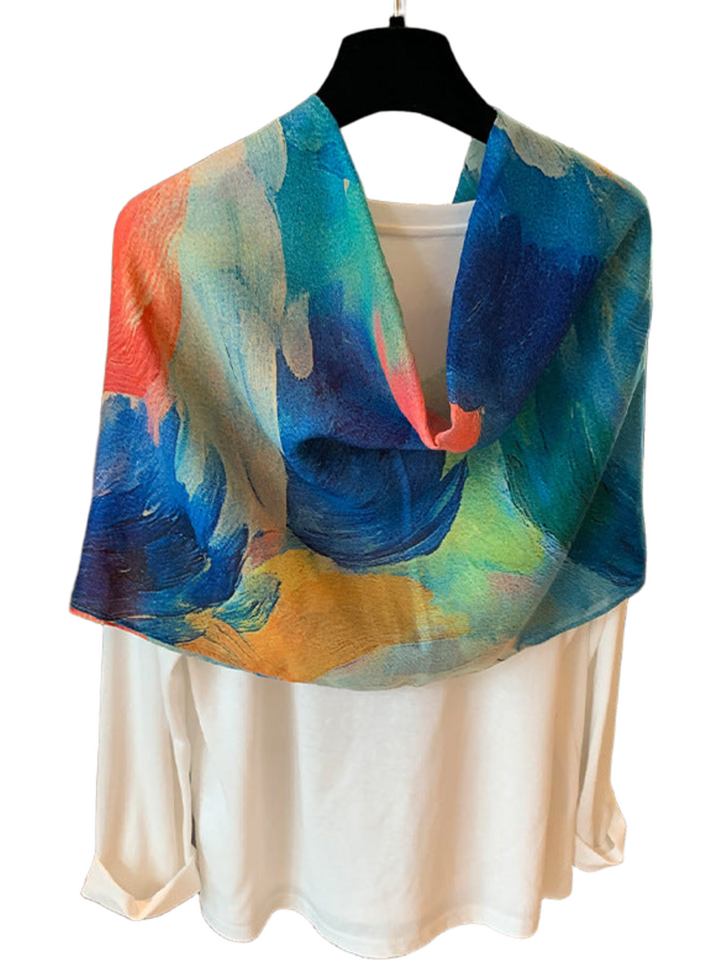 Blue scarf looped over a white top, showing blue, teal and yellow painterly sections