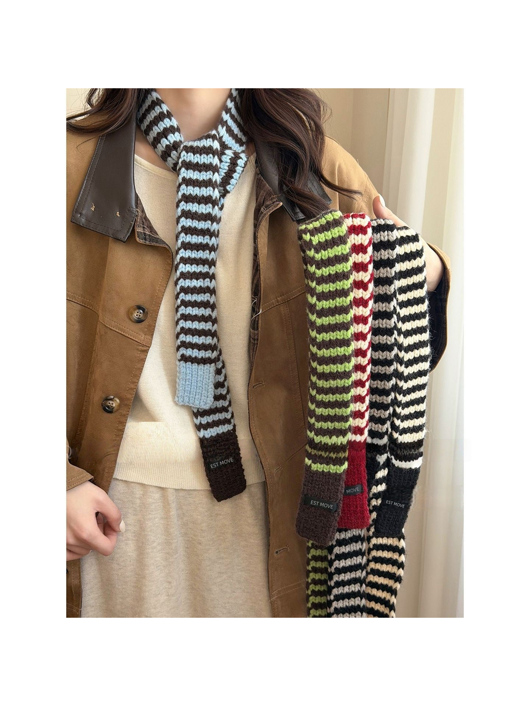 Striped knit scarves shown worn in Blue and held in contrasting colorways
