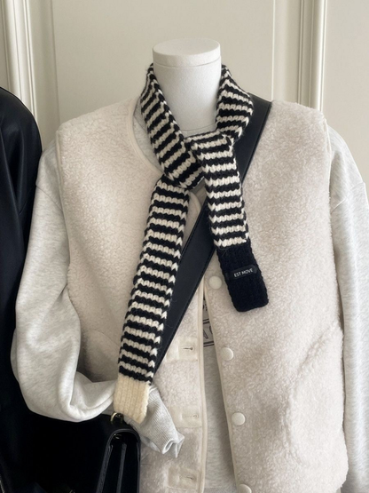 White striped knit scarf with contrasting end panels, knotted on a mannequin