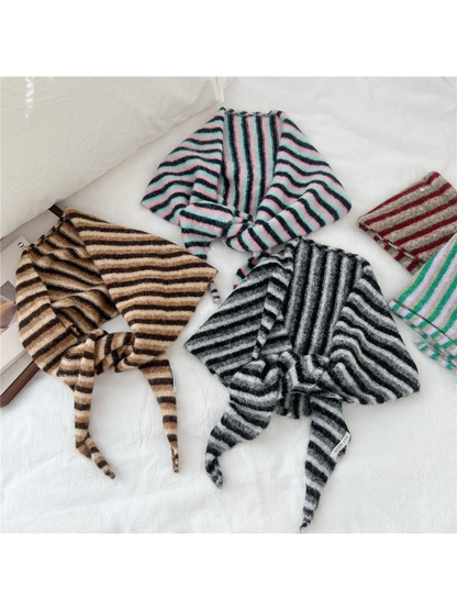 Striped fuzzy scarves displayed together in several colors