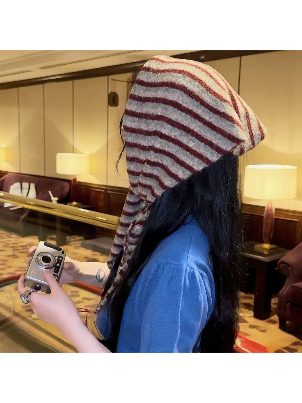 Striped scarf worn over the head, side and rear view
