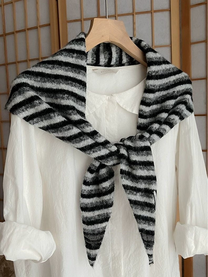 Black striped scarf tied over a white shirt