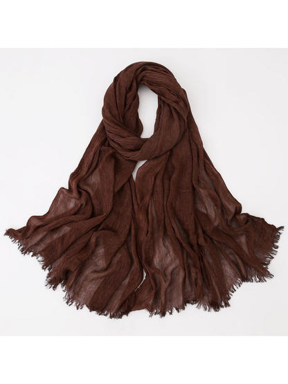 Brown scarf looped with crinkled texture and fringed edges