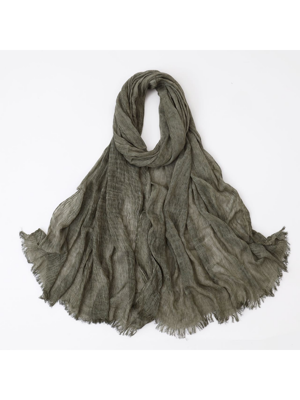 Green scarf looped with crinkled texture and fringed edges