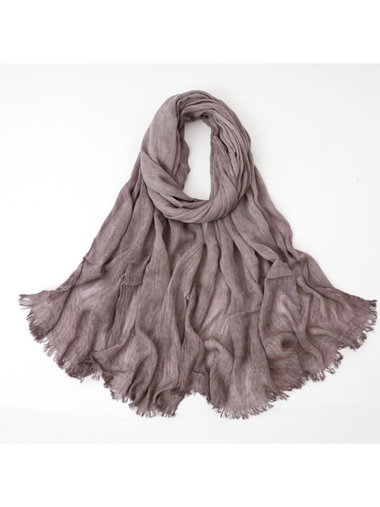 Purple scarf looped with crinkled texture and fringed edges