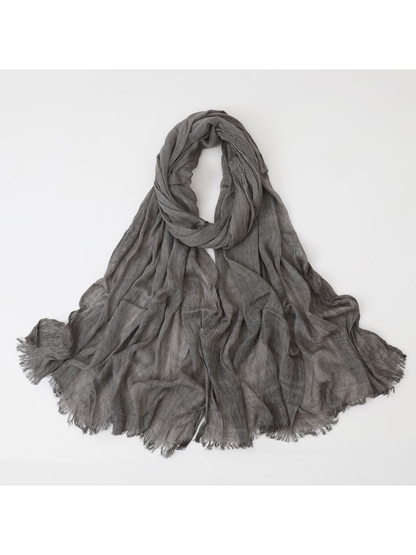 Gray scarf looped with crinkled texture and fringed edges