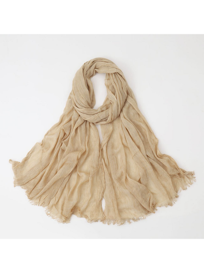 Beige scarf looped with crinkled texture and fringed edges