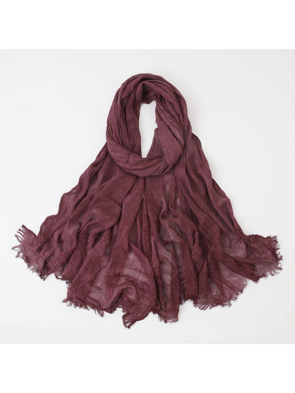 Burgundy scarf looped with crinkled texture and fringed edges
