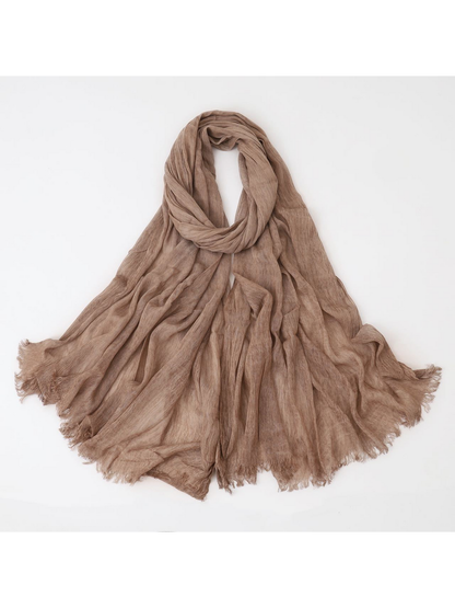 Khaki scarf looped with crinkled texture and fringed edges