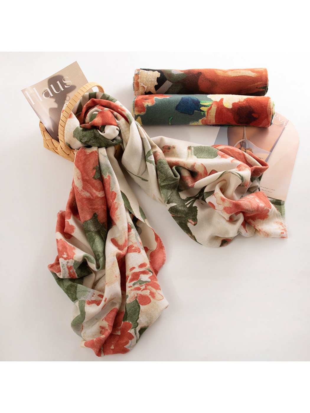 Floral scarf looped through a basket beside two rolled color options