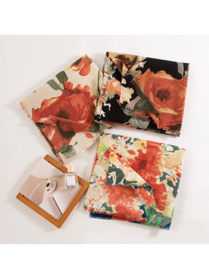 Three folded floral scarves showing different base colors and large flower patterns