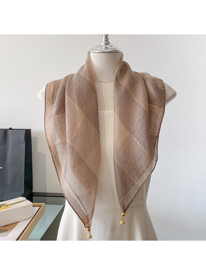 Coffee scarf draped on a mannequin with metallic-look lines and gold-tone end ornaments