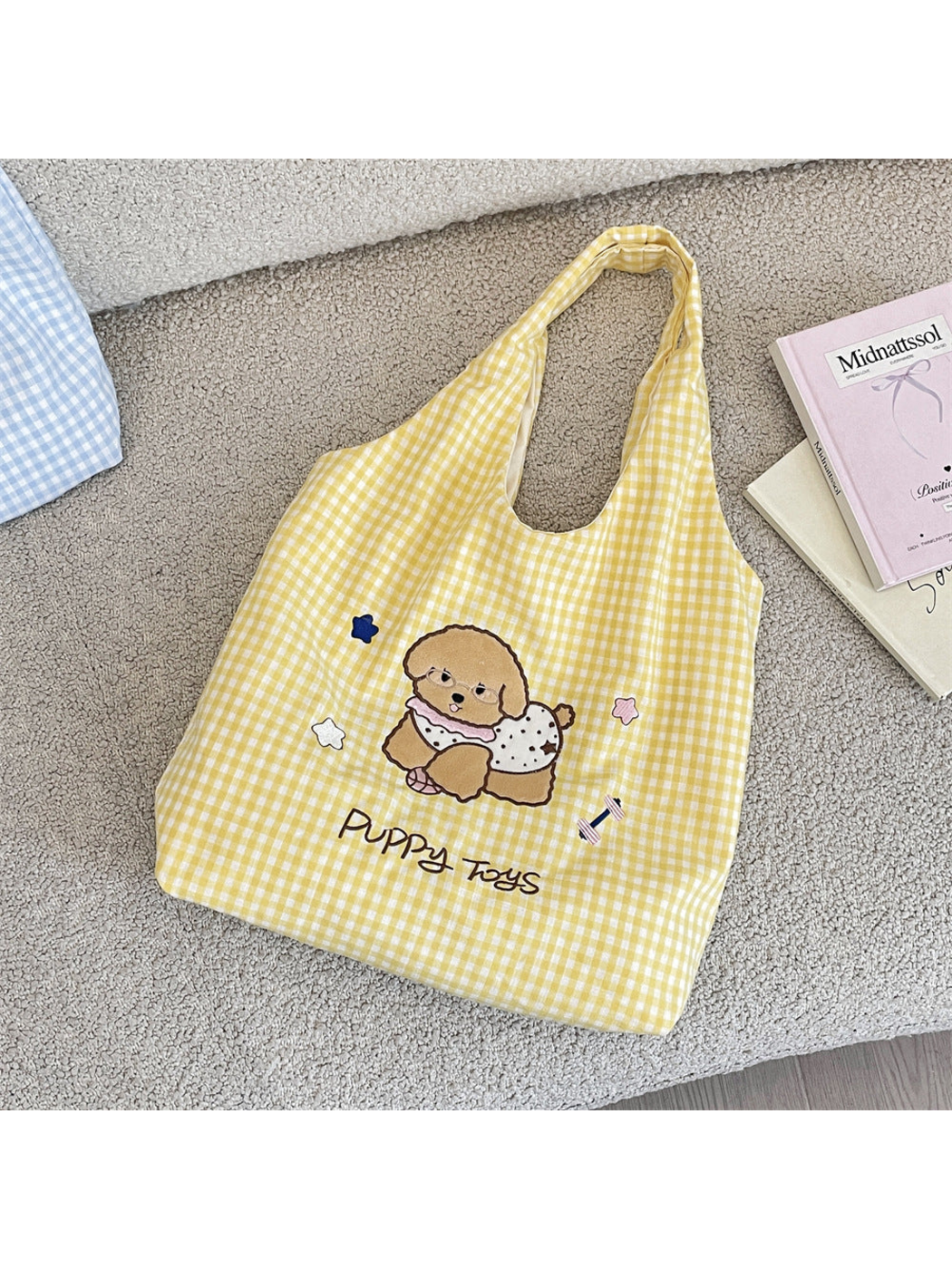 Yellow gingham tote bag with a glasses-wearing cartoon dog and Puppy Toys lettering, flat view