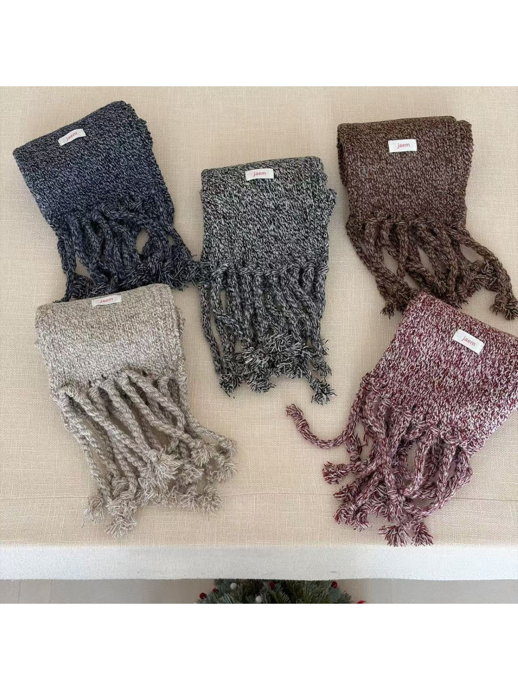 Marled knit scarves in Brown, Gray, Navy, Burgundy and Black with twisted fringe displayed together