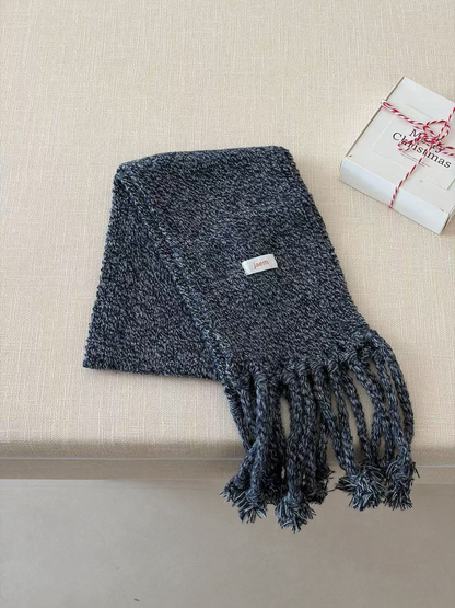 Navy marled knit scarf folded diagonally with long twisted fringe