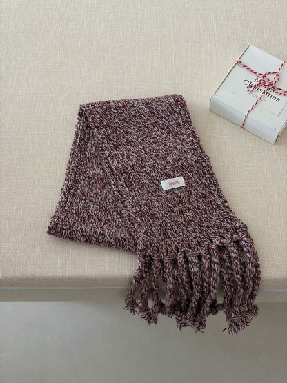 Burgundy marled knit scarf folded with long twisted fringe