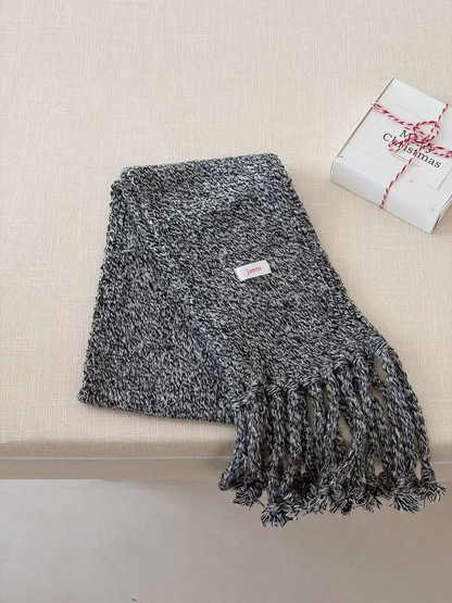 Black marled knit scarf folded with long twisted fringe