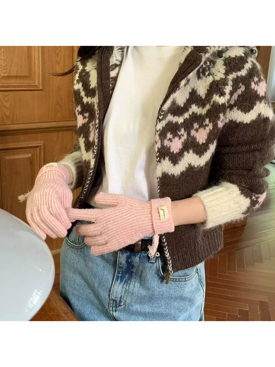 Pink ribbed gloves worn with folded cuffs visible