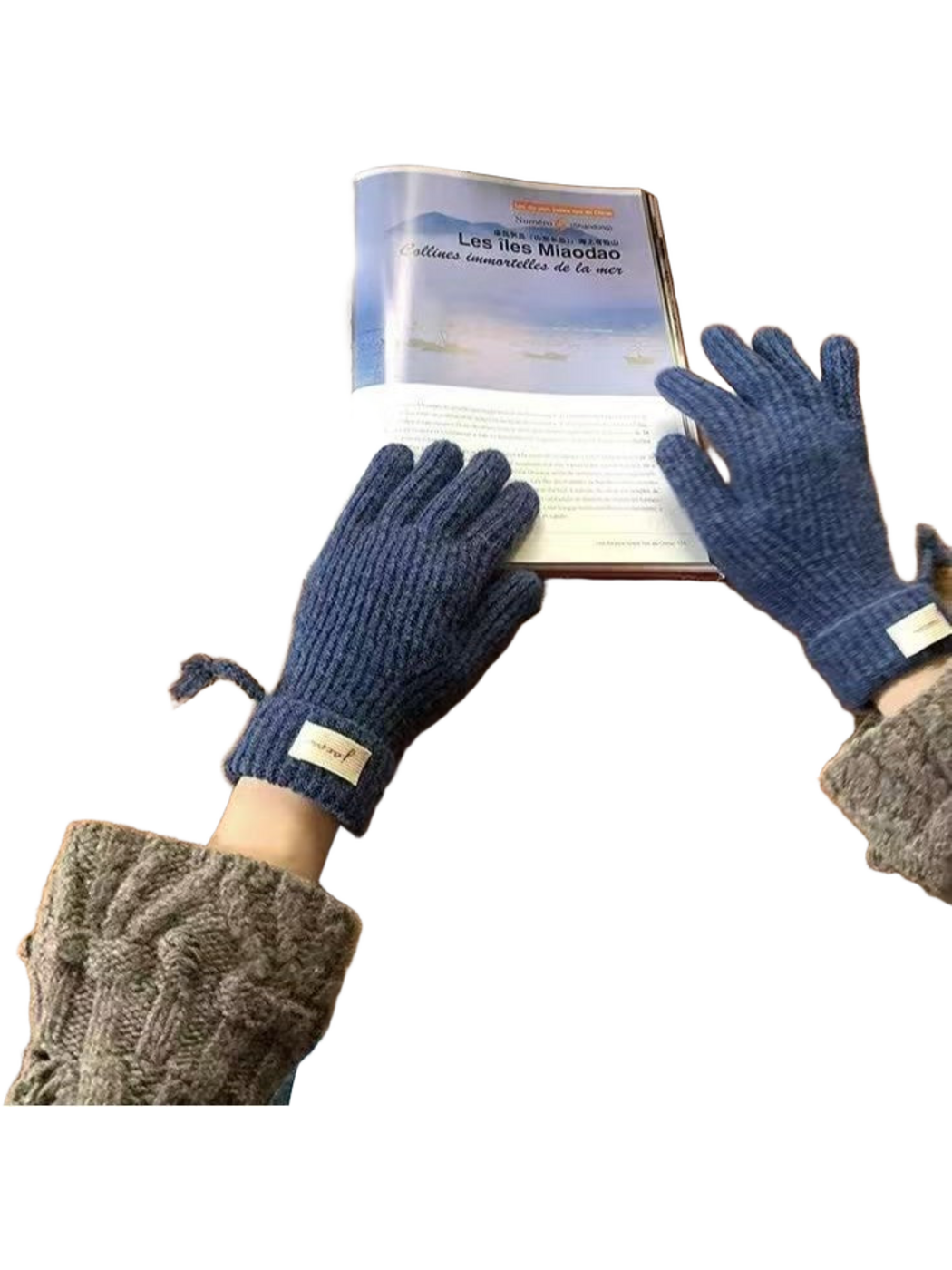 Navy ribbed gloves worn beside an open book