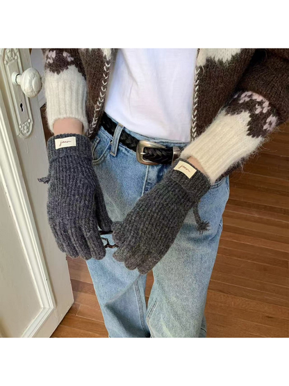 Gray ribbed gloves worn with folded cuffs and cuff labels visible
