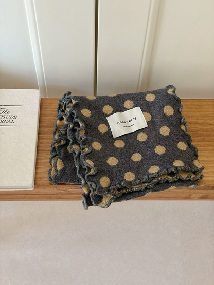 Gray scarf with beige polka dots and ruffled edges, folded view