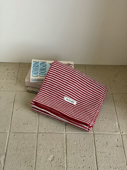 Red striped knit scarf folded with its KN STUDIO label visible