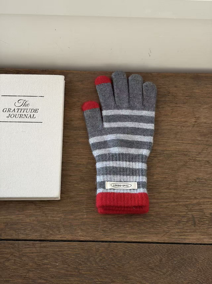 Gray striped glove with red cuff and contrasting thumb and index fingertips