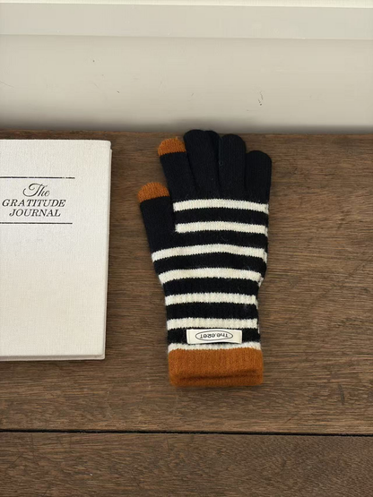 Black glove with ivory stripes, ochre cuff and contrasting fingertips