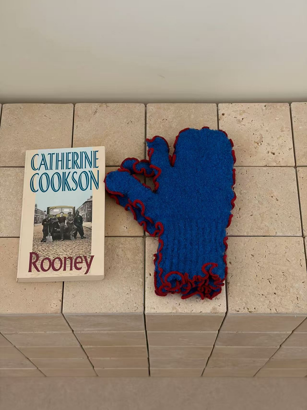 Blue mittens with red ruffled edging and ribbed cuffs