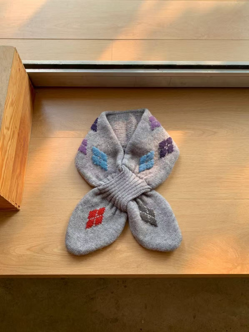 Light Gray knit scarf with blue, purple, red and dark gray motifs