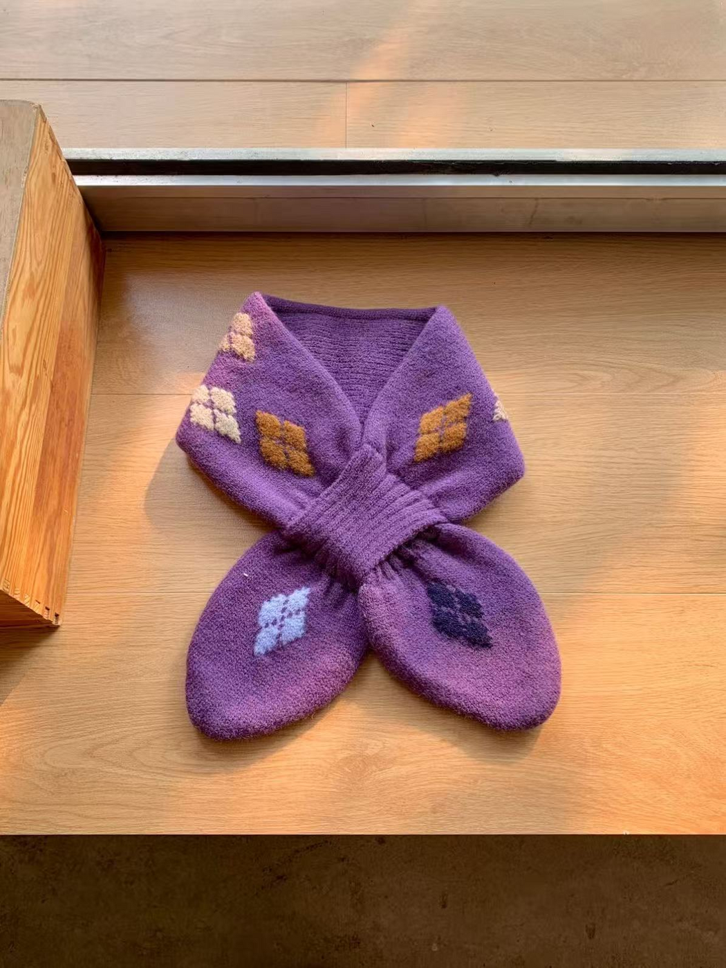 Purple knit scarf with cream, ochre, pale blue and dark purple geometric motifs