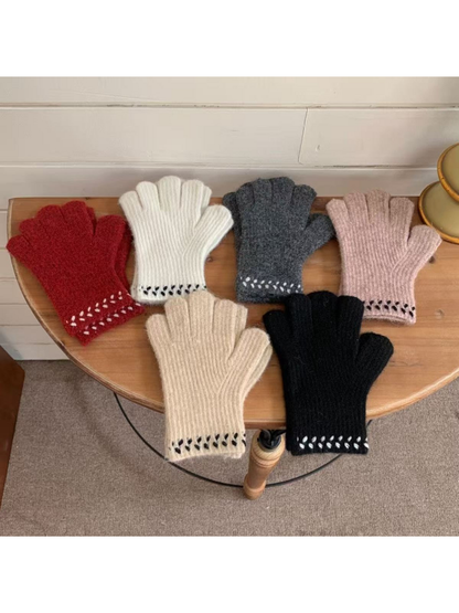 Six glove colorways displayed together with contrasting cuff embroidery