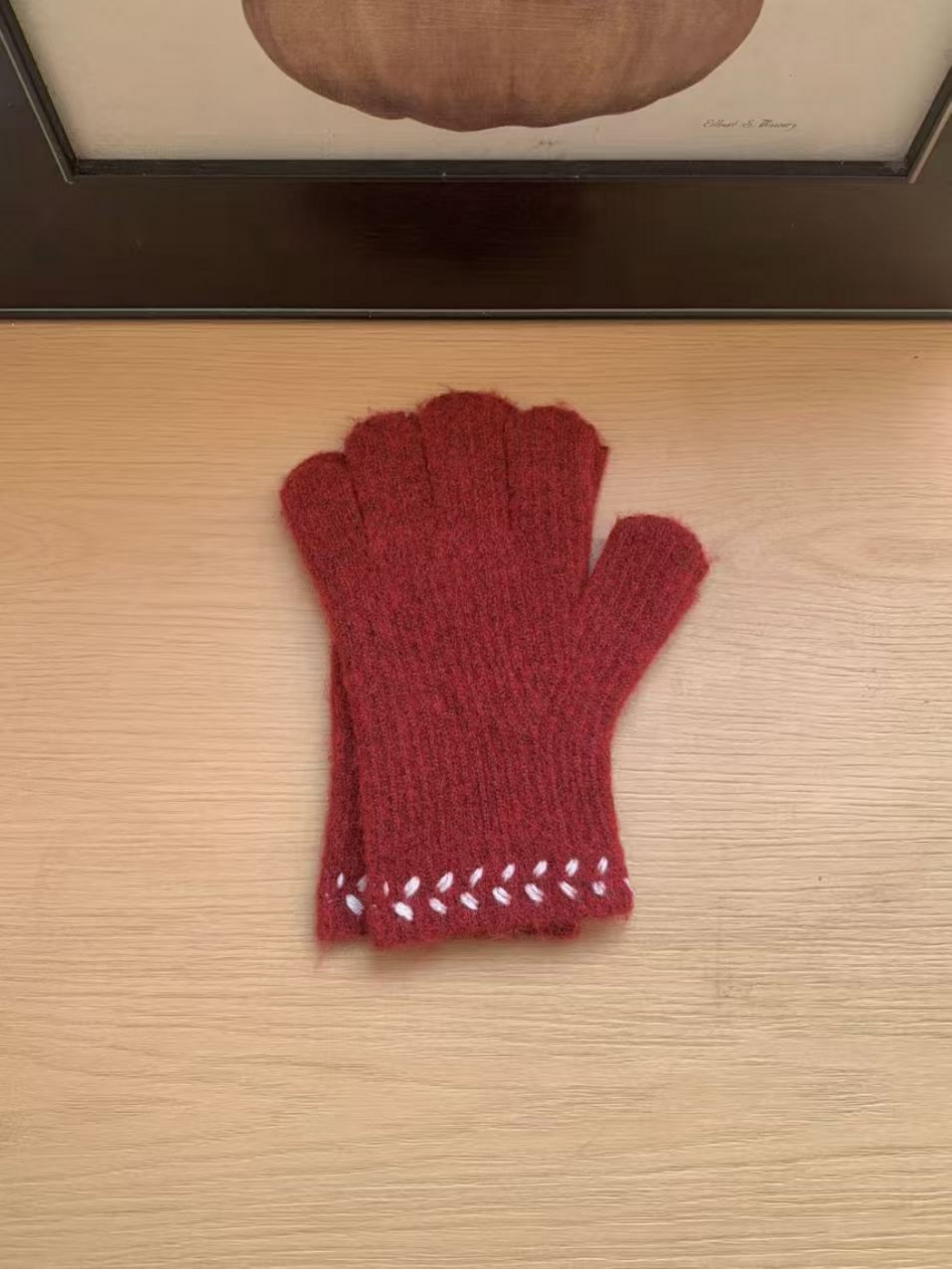 Burgundy gloves with contrasting leaf-like cuff embroidery