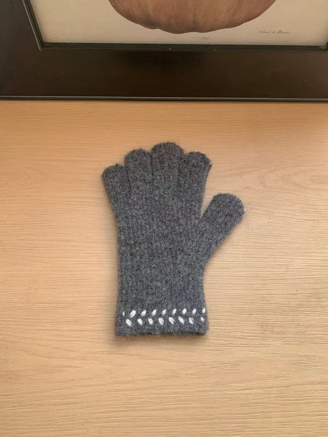 Gray gloves with fuzzy surface texture and contrasting cuff embroidery