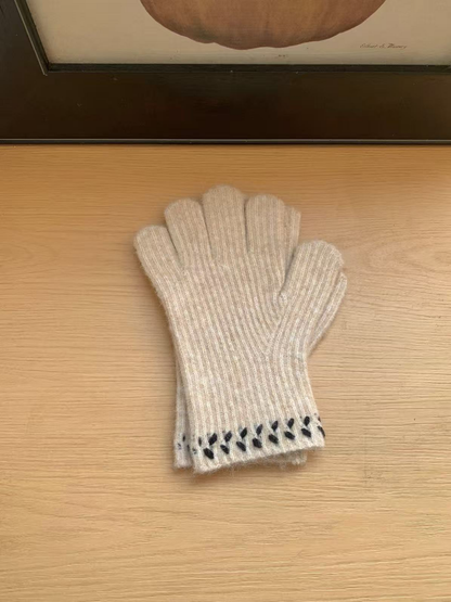 Beige ribbed gloves with dark leaf-like cuff embroidery