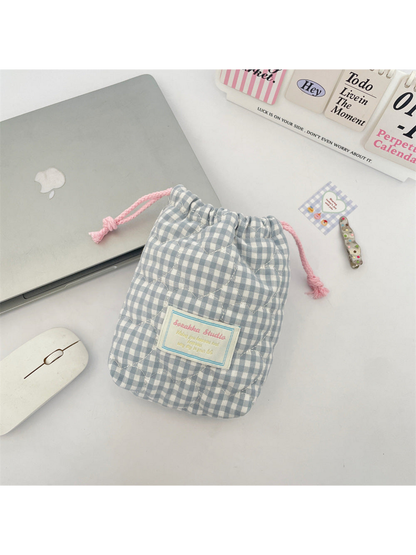 Blue gingham drawstring pouch with curved quilting and pink drawcords, front view