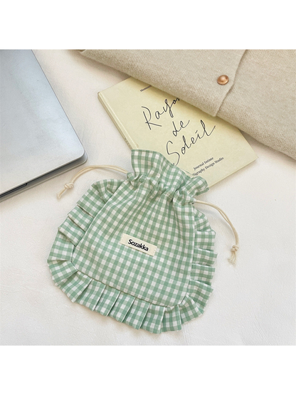 Green gingham drawstring pouch with ruffled sides and rounded bottom