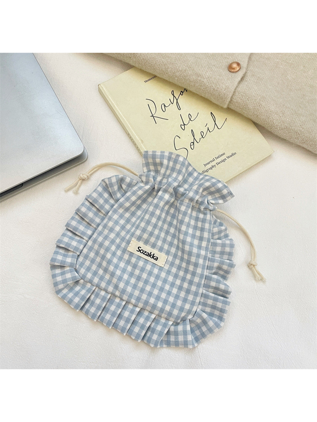 Gray gingham drawstring pouch with cream cords and ruffled trim