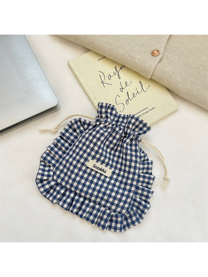 Navy gingham drawstring pouch with ruffled trim, flat view
